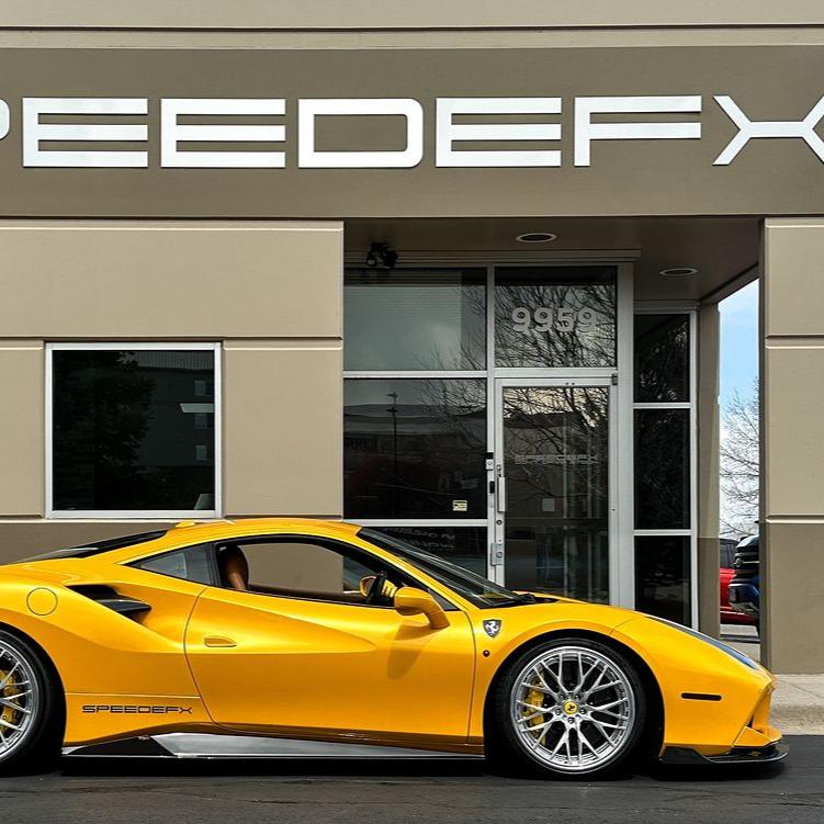 Mercedes-AMG GT sports car wrapped in Inozetek Supergloss yellow vinyl parked on an urban street with graffiti walls.