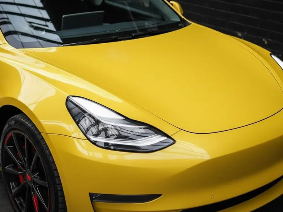 Tesla 3 wrapped in Gloss HX20000 Daffodil Yellow automotive vinyl film HX20123B