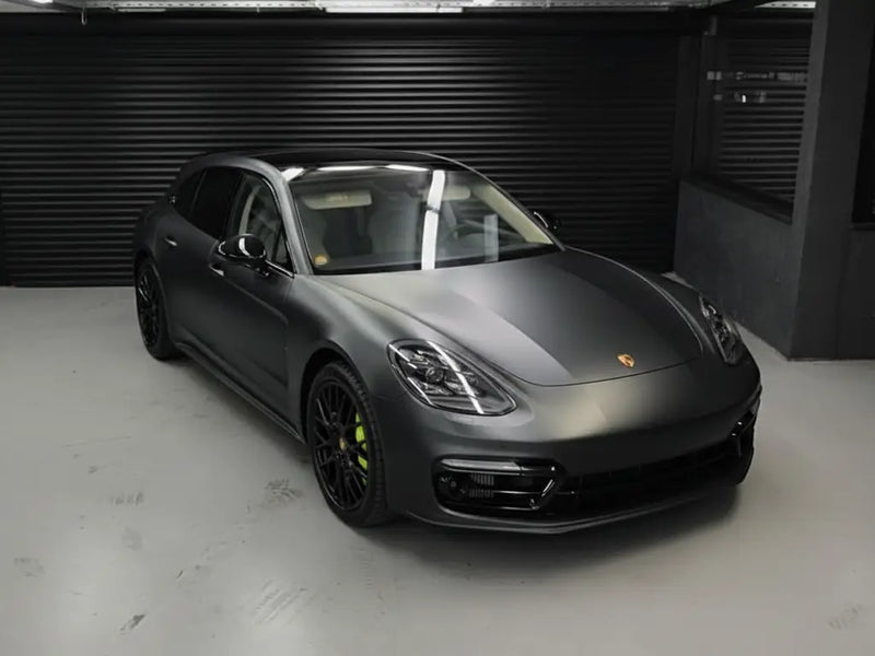Porsche Panamera wrapped in Matte HX20000 Deep Black wrap film HX20NPRM