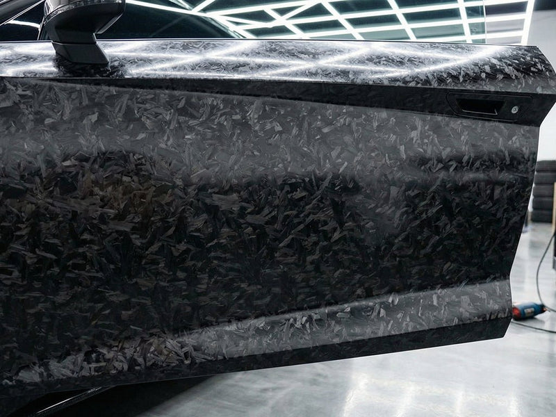 Tesla 3 wrapped in Carbon Fiber HX30000 Black Forged car wrap film HX30CAF89S