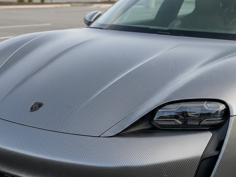 Porsche Taycan wrapped in Gloss HX30000 Graphite Gray Carbon Fiber automotive vinyl film HX30CAGGRB