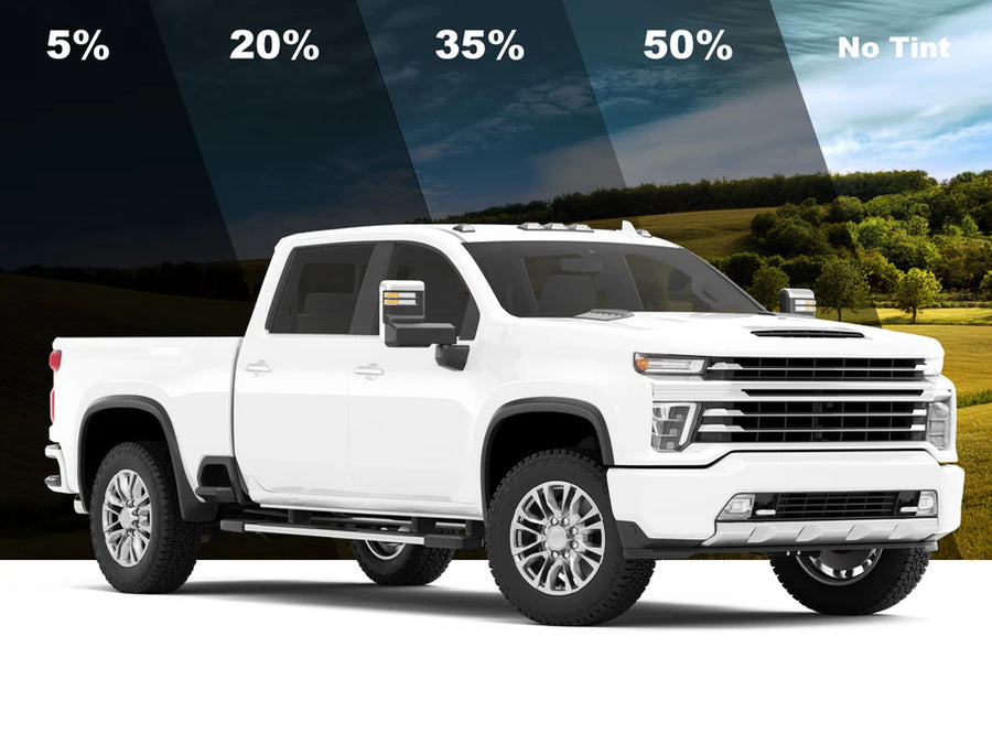 White pickup truck with different tint percentages displayed on a scenic background
