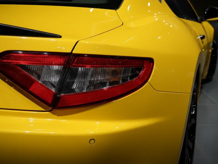 Aston Martin V8 Vantage wrapped in Hexis Gloss HX20000 Daffodil Yellow restyling film HX20123B