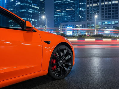 Tesla 3 wrapped in Hexis Gloss HX20000 Fluorescent Orange restyling film HX20614B