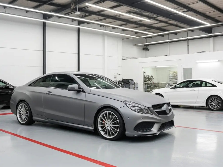 Mercedes-Benz E-Class Coupe wrapped in Hexis Satin HX20000 Metallic Grey restyling film HX20G03S