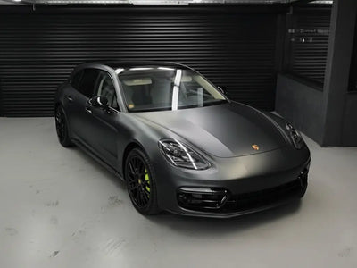 Porsche Panamera wrapped in Matte HX20000 Deep Black wrap film HX20NPRM