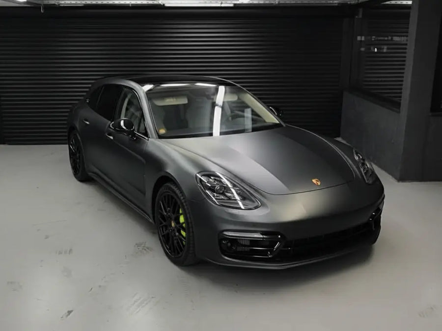 Porsche Panamera wrapped in Matte HX20000 Deep Black wrap film HX20NPRM