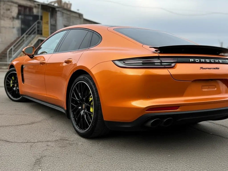 Porsche Panamera wrapped in Gloss HX20000 Aurora Orange automotive vinyl film HX20OAUB