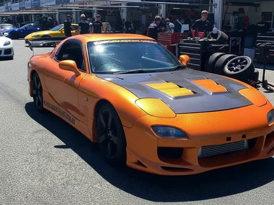 Mazda RX-7 wrapped in Hexis Gloss HX20000 Aurora Orange vinyl wrap HX20OAUB