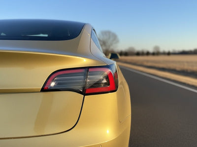 Tesla 3 wrapped in Hexis Gloss HX20000 Zeus Gold wrap film HX20P001