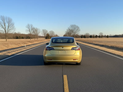 Tesla 3 wrapped in Hexis Gloss HX20000 Zeus Gold car wrap film HX20P001