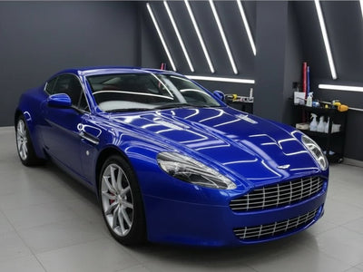 Aston Martin V8 Vantage wrapped in Hexis Gloss HX20000 Triton Blue vinyl wrap HX20P005