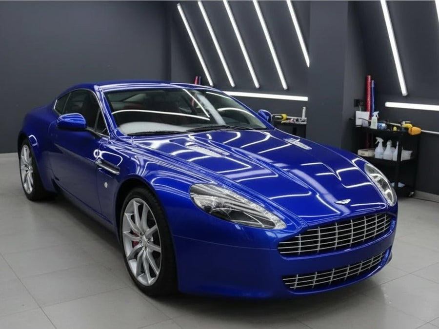 Aston Martin V8 Vantage wrapped in Hexis Gloss HX20000 Triton Blue vinyl wrap HX20P005