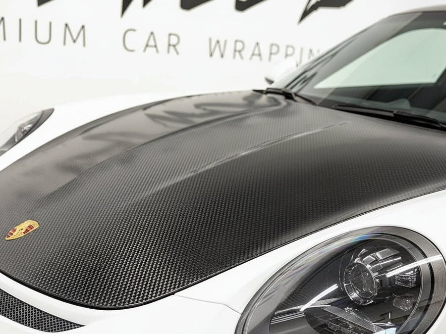 Porsche 911 wrapped in Hexis Ultra Gloss HX30000 Petroleum Black Carbon Fiber restyling film HX30CANPEB