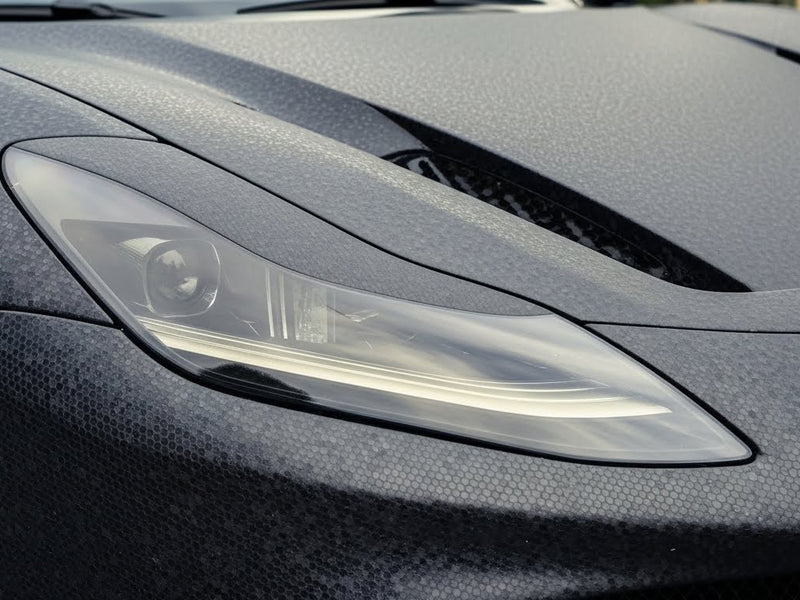 Ferrari F12 Berlinetta wrapped in None HX30000 Black Honeycomb restyling film HX30CAF89S