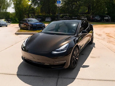 Tesla Model 3 wrapped in SuperGloss Metallic Black vinyl wrap